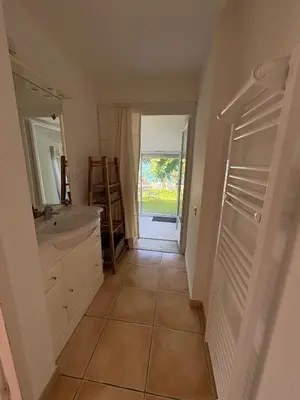 a bathroom with a tub and a sink and a mirror at Logement avec jardin et terrain de pétanque privé in Venelles