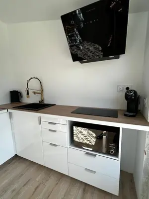 a kitchen with a counter with a microwave and a sink at L'Essentiel Room in Velaux
