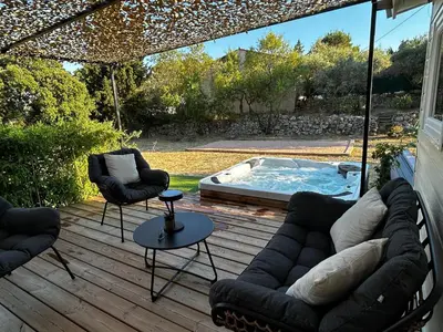 a patio with a couch and chairs and a pool at L'Essentiel Room in Velaux