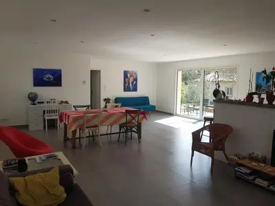 a living room with a table and chairs at L'embellie in Châteaurenard