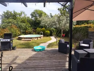 a patio with a pool table and a table and chairs at Maison Viens in Viens