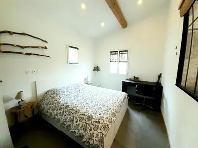 a bedroom with a bed and a dresser in it at Maison Viens in Viens
