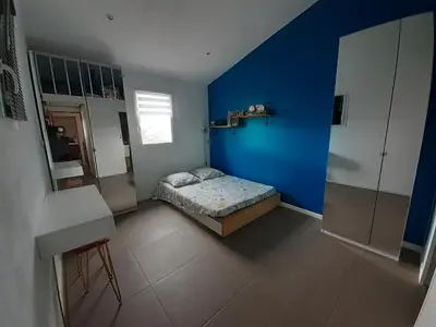 a bedroom with a blue wall and a bed at Maison Viens in Viens