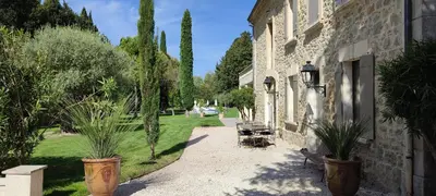 a courtyard with potted plants next to a building at Mas Cabannes en Provence in Cabannes