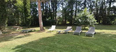 a group of chairs and a picnic table in a park at Mas Cabannes en Provence in Cabannes