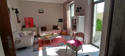 a living room with a table and chairs at Mas Cabannes en Provence in Cabannes
