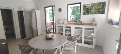a dining room with a table and chairs in a kitchen at Mas Cabannes en Provence in Cabannes