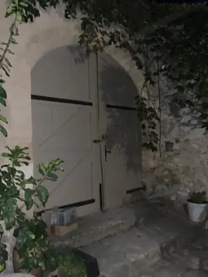 an archway with a door in a stone wall at Maisonnette de charme 60m2 in Robion en Luberon