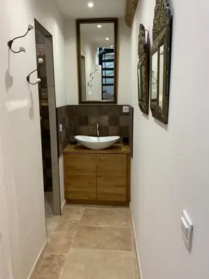 a bathroom with a sink and a mirror at Maisonnette de charme 60m2 in Robion en Luberon