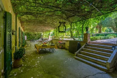 an empty building with stairs and tables and plants at 18Th Century Bastide With Heated Pool In Provence in Apt