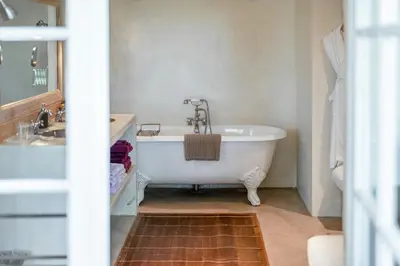 a bathroom with a white tub and a sink at 18Th Century Bastide With Heated Pool In Provence in Apt