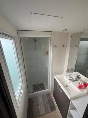 a bathroom with a shower and a sink at mobil home AU SOLEIL in La Roque-dʼAnthéron