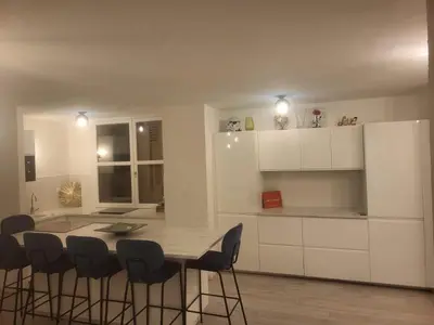 a kitchen with a table and chairs and a refrigerator at Espace Forbin in Aix-en-Provence