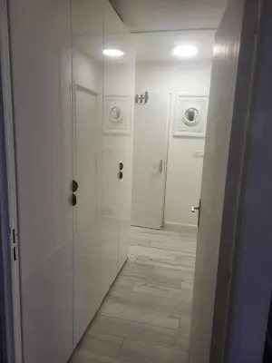 a white bathroom with a shower and a washing machine at Espace Forbin in Aix-en-Provence