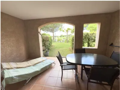 a dining room with a table and a window at Appartement de charme sur le domaine de Pont Royal à Mallemort, en rez-de-jardin avec terrasse & piscine et vue sur le Golf in Mallemort