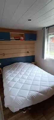 a large white bed in a bedroom with a window at Mobile Home en Provence in La Roque-dʼAnthéron