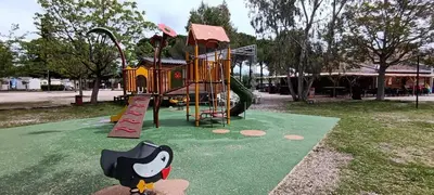 a playground in a park with a play equipment at Mobile Home en Provence in La Roque-dʼAnthéron