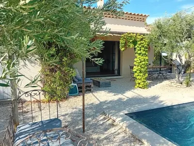 a villa with a swimming pool and a house at Villa de charme à Cucuron au pied du luberon in Cucuron