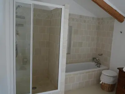 a bathroom with a shower and a bath tub at Oppède Villa with Private Pool in Oppède
