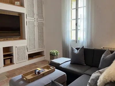 a living room with a couch and a tv at Oppède Villa with Private Pool in Oppède