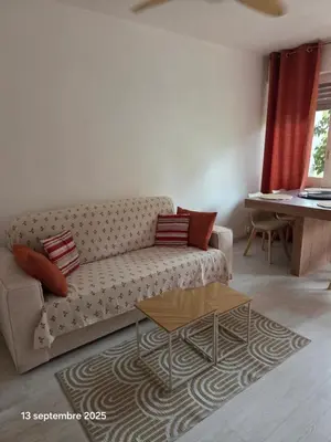 a living room with a couch and a table at La Pineda de Provence in Aix-en-Provence