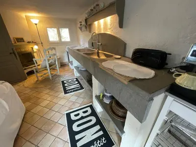 a kitchen with a sink and a counter top at Petite Maison provencale in Lagnes