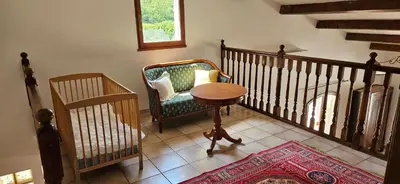 a room with a chair and a table and a staircase at Villa en Provence avec piscine in Sénas