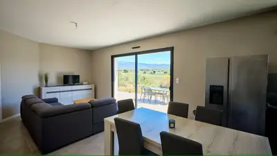 a living room with a couch and a table at Cap sur le Ventoux in Mormoiron