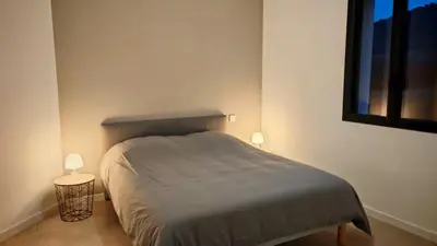a bedroom with a bed with two lights on it at Cap sur le Ventoux in Mormoiron