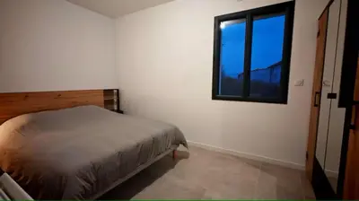 a bedroom with a bed and a window at Cap sur le Ventoux in Mormoiron