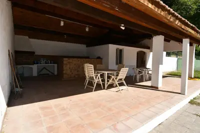 a patio with a table and chairs under a pavilion at Villa Sainte BARBE in Loriol-du-Comtat