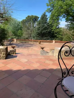 a bench sitting on a brick patio at Villa Sainte BARBE in Loriol-du-Comtat
