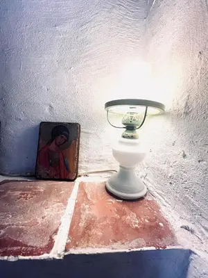 a lamp sitting on a table next to a painting at La Biscornue in Lauris