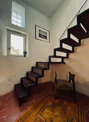 a living room with a staircase in a house at La Biscornue in Lauris