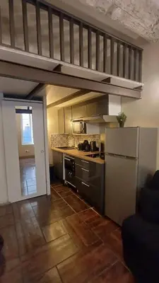 a room with a living room with a staircase in it at La cachette d'Aix in Aix-en-Provence