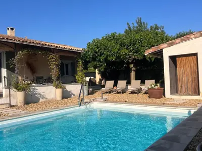 a swimming pool in front of a house at Haus PETIT REVE in Oppède in Oppède