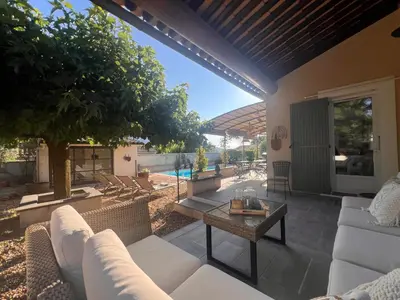 a patio with white furniture and a pool at Haus PETIT REVE in Oppède in Oppède