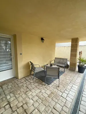 a patio with chairs and a table and a couch at Studio cosy avec coin nuit in Pélissanne