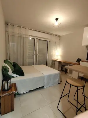 a bedroom with a bed and a table and chairs at Studio plein centre in Aix-en-Provence