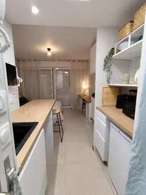 a kitchen with white cabinets and a counter top at Studio plein centre in Aix-en-Provence
