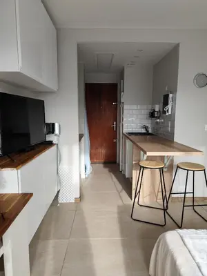 a small kitchen with a counter and a table in a room at Studio plein centre in Aix-en-Provence