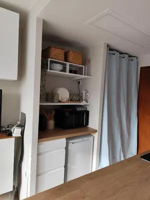 a kitchen with white cabinets and white shelves at Studio plein centre in Aix-en-Provence