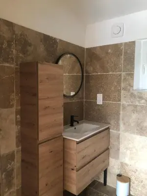 a bathroom with a sink and a mirror at L'olivier in Aureille