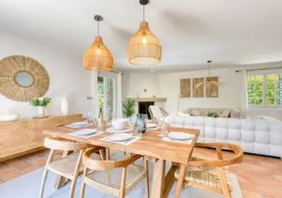 a living room with a wooden table and chairs at Villa La Belle Vie in Gordes