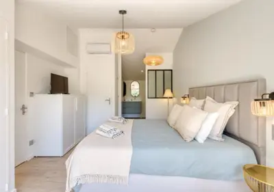 a bedroom with a large blue bed with white pillows at Villa La Belle Vie in Gordes
