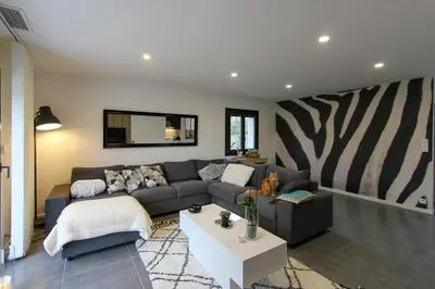 a living room with a couch and a table at Villa rosalie L'Isle-sur-la-Sorgue in LʼIsle-sur-la-Sorgue