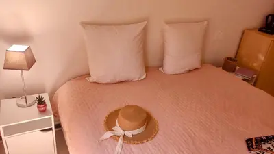 a bed with a hat on top of it at Provence apartments in Aix-en-Provence