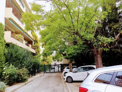 a street with cars parked next to a tree at Provence apartments in Aix-en-Provence