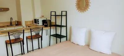 a room with a bed and a counter with a microwave at Provence apartments in Aix-en-Provence