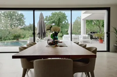 a dining room with a wooden table and chairs at Villa contemporaine de luxe in Aix-en-Provence
